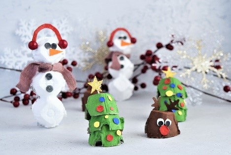 Handmade Christmas ornaments on festive background.