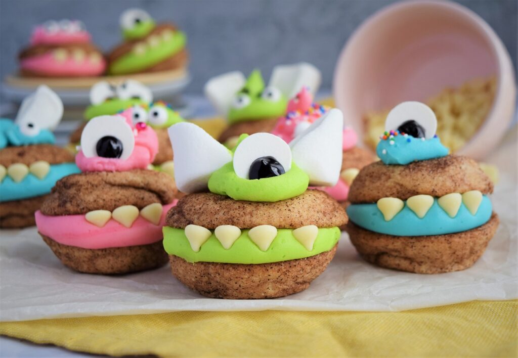 Colorful monster-themed decorated cookies on table