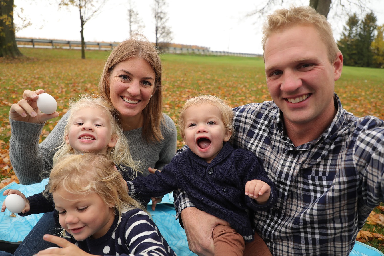 Young family enjoying picnic in autumn park