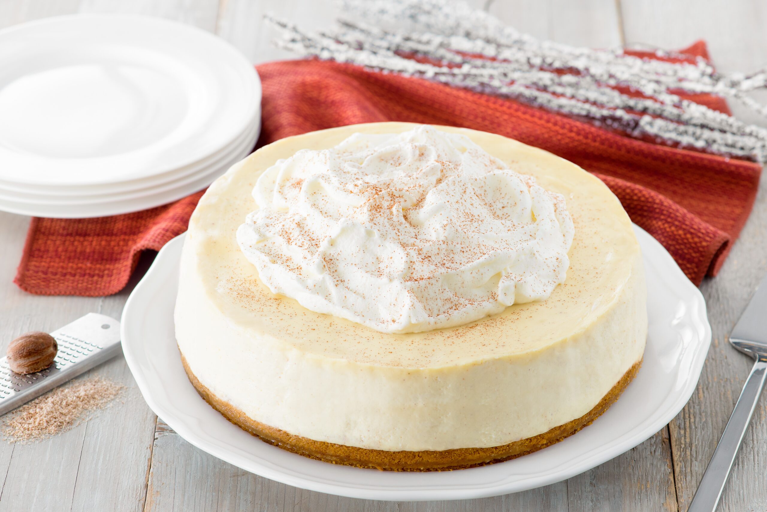 Homemade cheesecake with whipped cream topping on plate
