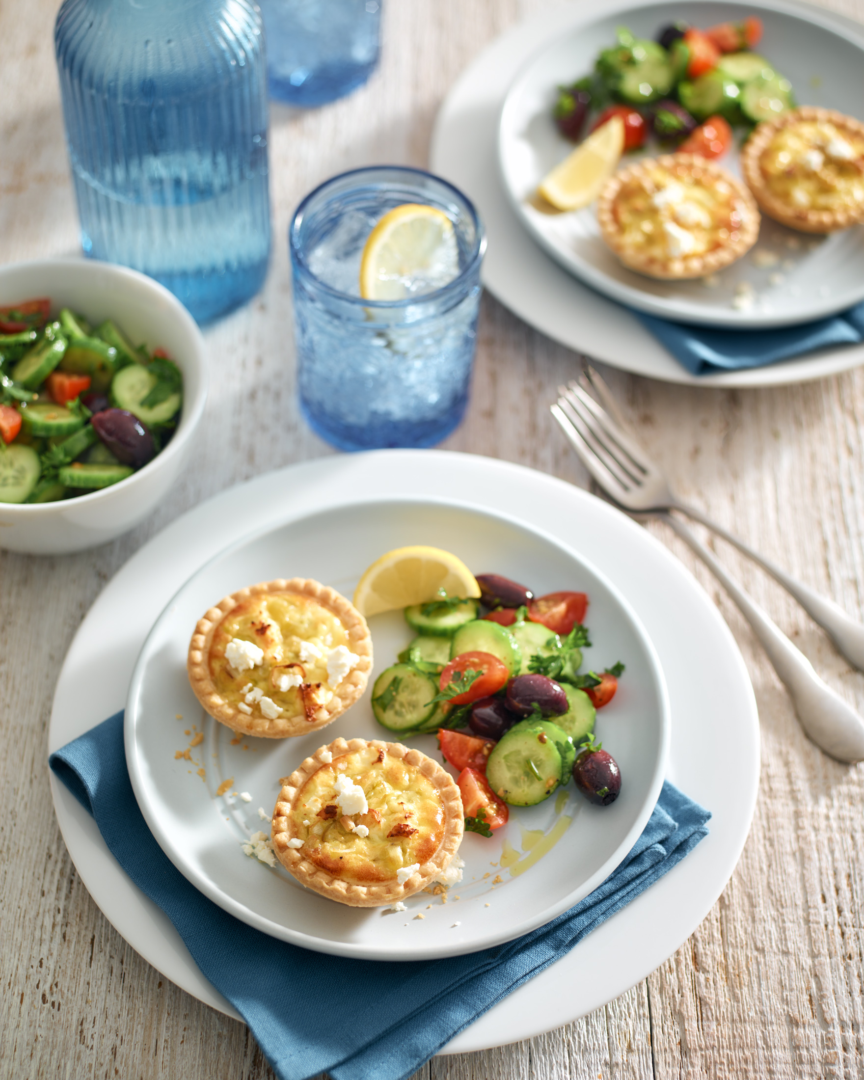 Fresh mini quiches with side salad on table