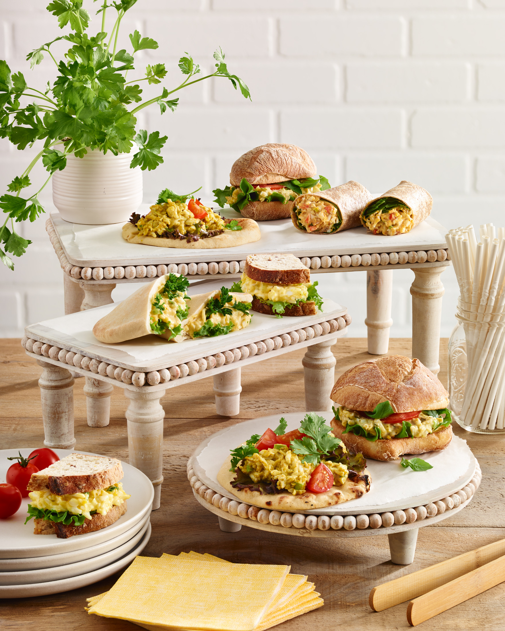 Assorted vegetarian sandwiches on display on tiered stands
